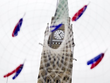 The Peace Tower clock is framed in a dream catcher on Parliament Hill during Canada Day celebrations in downtown Ottawa Saturday, July 1, 2017.