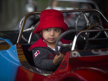 People didn't let the weather stop them from heading out to celebrate Canada Day in Barrhaven at Clarke Fields Saturday July 1, 2017. Two-year-old Oaken Gandhi was all business as he was driving car five in the midway.