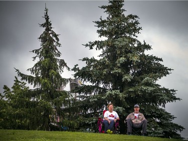 People didn't let the weather stop them from heading out to celebrate Canada Day in Barrhaven at Clarke Fields Saturday July 1, 2017. Constance Steinborn and husband Colin Hollingworth sit on the hill in the park watching the performances on stage.