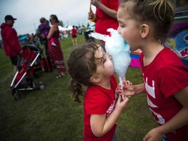 People didn't let the weather stop them from heading out to celebrate Canada Day in Barrhaven at Clarke Fields Saturday July 1, 2017. Sisters three-year-old Fiona and five-year-old Keira Cleary share some cotton candy.