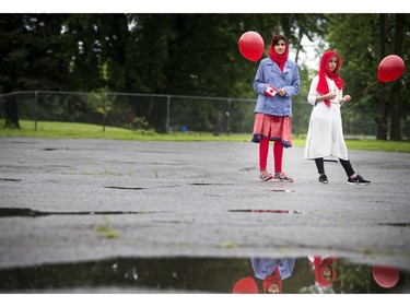 To celebrate Canada Day the Ahmadiyya Muslim Jama'at Ottawa organized a Canada Day Festival at Baitun Naseer Mosque in Cumberland Saturday July 1, 2017. L-R 13-year-old Aneeqah Mehmood and 12-year-old Areeka Noor  stand with balloons during the speeches Saturday.