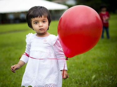 To celebrate Canada Day the Ahmadiyya Muslim Jama'at Ottawa organized a Canada Day Festival at Baitun Naseer Mosque in Cumberland Saturday July 1, 2017. One and a half year old Rabeeta Ahmed with her red balloon Saturday.