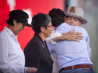 L-R Daisy Wenjack, Pearl Wenjack and Prime Minister Justin Trudeau hugged Gord Downie of the Tragically Hip during WE Day Canada Sunday July 2, 2017 on Parliament Hill.