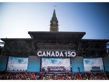 Gord Downie of the Tragically Hip and Prime Minister were on the stage as the youth choir that sang The Stranger from Downie's Secret path album during WE Day Canada Sunday July 2, 2017 on Parliament Hill.