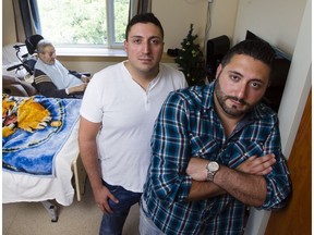Georges Nassrallah, left, and Daniel Nassrallah, right, are photographed with their grandfather, Georges Karam, background, in his room at the Garry J Armstrong home.