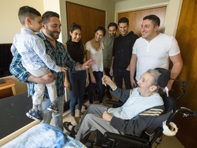 Georges Karam (in wheelchair), is visited by family members at the Garry J Armstrong home in Ottawa. Karam was assaulted by a PSW and the incident was caught on video. (Photo: Darren Brown/Postmedia)