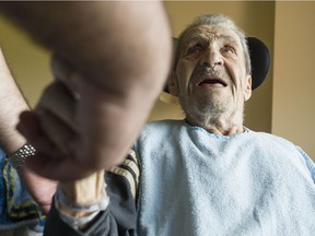 Georges Karam chats with his grandson, Daniel Nassrallah in his room at the Garry J Armstrong home in Ottawa Monday July 3, 2017. Georges Karam was assaulted by an orderly and the incident was caught on camera the family had previously installed in his room. (Darren Brown/Postmedia)