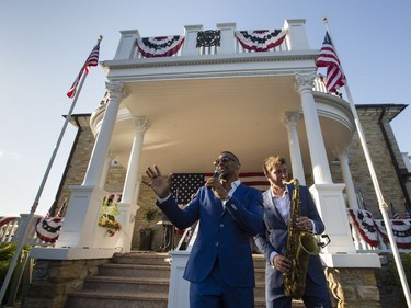 Singer Sean Jones, left, performs with his band, including saxophonist, Miles Raine, right, during the July 4th party at Lornado, the official residence of the United States Ambassador to Canada, Tuesday, July 4, 2017.