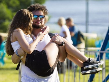 A man carries a woman in Bluesville during the opening night of the 2017 Ottawa Bluesfest Thursday, July 6, 2017. (Darren Brown/Postmedia) NEG: 126895
Darren Brown, Postmedia
