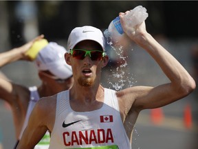 Canada's Evan Dunfee douses himself with water during the men's 50-kilometre race walk at the 2016 Summer Olympics in Rio de Janeiro on Aug. 19, 2016. AP Photo/Robert F. Bukaty