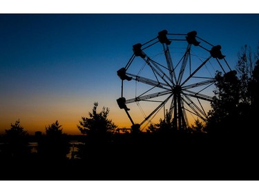 The sun sets as people take a ride on the ferris wheel at RBC Bluesfest.