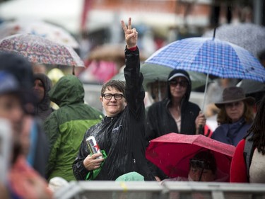 A woman gives a peace sign in the crowd at Gabrielle Shonk show at RBC Bluesfest Sunday July 9, 2017.