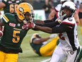 Redblacks linebacker Nicholas Taylor, right, tries to fight through a stiff-arm by Eskimos tailback Travon Van during last Friday's game at Edmonton. Taylor has an unspecified injury and his status for Wednesday's home game against the Alouettes remains uncertain. Ed Kaiser/Postmedia