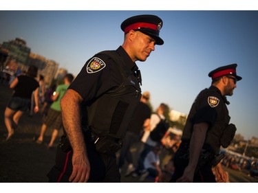 Ottawa Police officers walk through RBC Bluesfest on Saturday.  Ashley Fraser/Postmedia