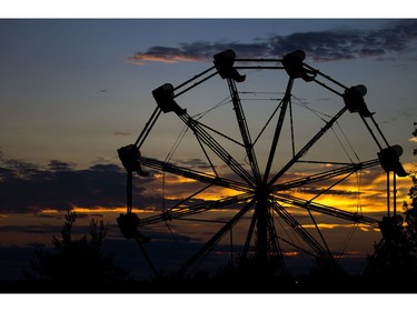 The sun set behind the ferris wheel at RBC Bluesfest on Saturday.  Ashley Fraser/Postmedia