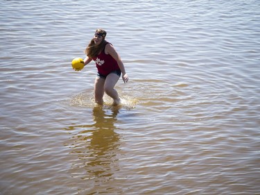 The hot sun made for perfect weather for HOPE Volleyball SummerFest that took over Mooney's Bay Park Saturday July 15, 2017. A young woman went into the water to get a ball that got away.