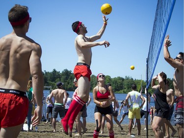 The hot sun made for perfect weather for HOPE Volleyball SummerFest that took over Mooney's Bay Park Saturday July 15, 2017. Bruno Lortie tips the ball over the net.