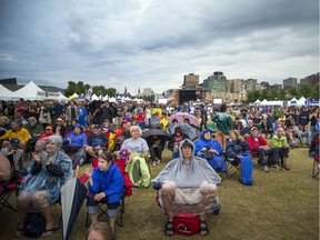 The crowd on closing night of Bluesfest Sunday was prepared for Ottawa's new normal: it seems there's always a chance of rain.