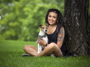 Selena Holder and her dog Rusty pose for a photo outside her home. Holder worked at the Rideau Street WeeMedical shop for about six weeks when it was raided, she now faces a possible criminal record, which could interfere with her plans to become a vet tech.