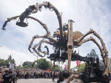 Kumo, the spider, chases Long Ma, the horse-dragon, not pictured, away from the National Gallery during a La Machine performance Friday.