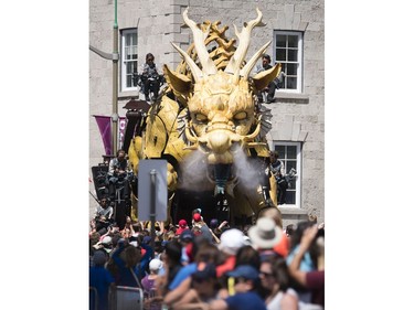 A few thousand people crowd the streets around the National Gallery to watch Long Ma, the dragon-horse, and Kumo, the spider, battle during La Machine's performance Friday. Darren Brown/Postmedia