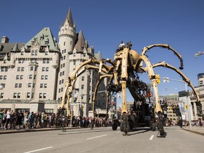 Kumo, the spider, passes the Fairmont Chateau Laurier on Wellington Street during a La Machine performance on Saturday.