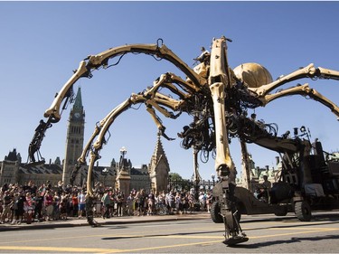 Kumo, the spider, passes Parliament Hill on Wellington St. during a La Machine performance Saturday, July 29 2017.