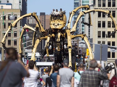 Kumo, the spider, climbs over traffic lights on Wellington St. during a La Machine performance Saturday, July 29 2017.