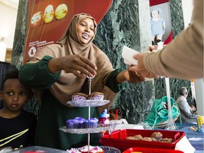 Hamdi Ahmed sells cupcakes at her table at the inaugural Somali Cultural Festival in Jean Pigott Place on Saturday, July 29, 2017.