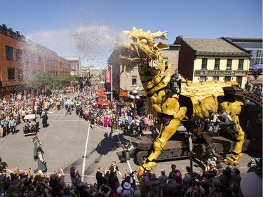 Long Ma, the horse-dragon, sprays people watching from a parking complex on Clarence Street.
