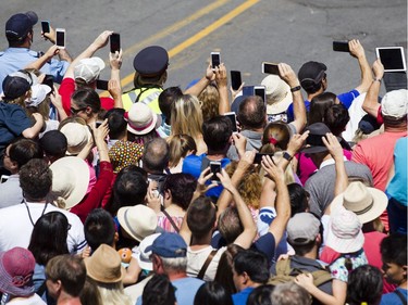 Onlookers film Long Ma, the horse-dragon, with cell phones as she makes her way through the Byward Market during a La Machine performance Saturday, July 29 2017.