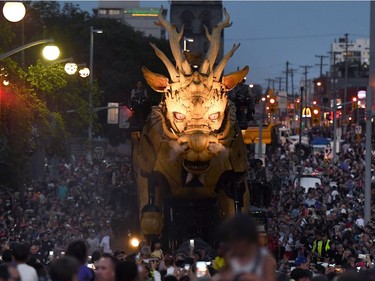 Crowds walk with Long Ma, the horse-dragon, on Elgin Street during the La Machine performance in Ottawa on Saturday, July 29, 2017.