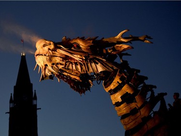 Long Ma, the horse-dragon, breathes out as she passes Parliament Hill during the La Machine performance in Ottawa on Saturday, July 29, 2017.