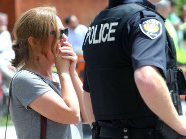 - A bystander covers her face, visibly upset by the sight of the home going up in flames. A three-alarm fire kept local firefighters hopping at a duplex at the corner of Concord Street North and Greenfield downtown Thursday (July 13, 2017) afternoon.  Julie Oliver/Postmedia
Julie Oliver, Postmedia