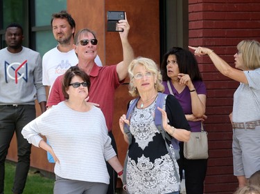 - Bystanders watch and take pictures as the duplex burns. A three-alarm fire kept local firefighters hopping at a duplex at the corner of Concord Street North and Greenfield downtown Thursday (July 13, 2017) afternoon.  Julie Oliver/Postmedia
Julie Oliver, Postmedia