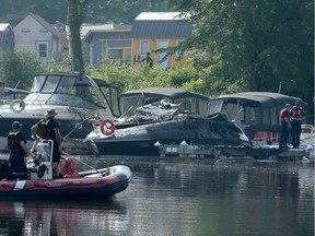 Firefighters are on the scene of boat fires at the Petrie Island marina Thursday (July 20, 2017) morning. Three boats were affected: one burnt and sank, another was burnt beyond repair (in picture) and another, beside that, suffered damage.  A Hazmat unit was also on scene to cordon off the gasoline in the water.