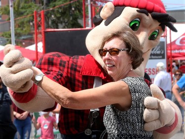 The Redblacks' mascot, Big Joe, takes Marlene Matheson for a surprise spin on the outdoor dance floor during the Lebanese festival.