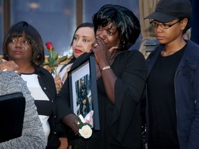 Ashton Dickson's mother, Donna Dickson, centre, wipes away tears as people speak fondly of her son at a vigil on Wednesday, July 26, 2017.