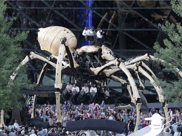 Kumo the spider and Long Ma the dragon-horse battled beside the Shaw Centre in downtown Ottawa as part of La Machine's Friday evening performance. Julie Oliver/Postmedia