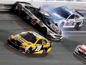 Kevin Harvick (4) is hit by Dale Earnhardt Jr. (88) after he cut a tire as Matt Kenseth (20) avoids the crash during the NASCAR Cup auto race at Daytona International Speedway, Saturday, July 1, 2017, in Daytona Beach, Fla. (AP Photo/Bill Friel)