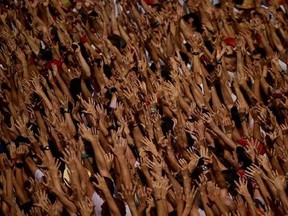 Revellers hold up their arms during the launching of the &#039;Chupinazo&#039; rocket, to celebrate the official opening of the 2017 San Fermin Fiestas in Pamplona, Spain, Thursday July 6, 2017. The first of eight days of the running of the bulls along the streets of the old quarter of Pamplona starts Friday. (AP Photo/Alvaro Barrientos)