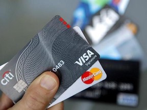 In this June 15, 2017, photo, credit cards are seen in Haverhill, Mass. When a credit card issuer reduces your credit limit, raises your interest rate or cancels your account, you may feel blindsided. But there are things you can do to recover. (AP Photo/Elise Amendola)