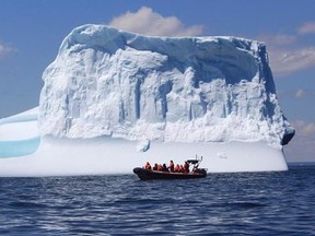 A tour boat cruises pass an iceberg off the coast of Bonavista, N.L. in this undated handout image. Photos of spectacular icebergs on social media are drawing visitors from all over the world to Newfoundland and Labrador. THE CANADIAN PRESS/HO-Discovery Sea Adventures tour company-Bob Currie