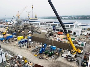 A Navy ship undergoes a mid-life refit at the Irving Shipbuilding facility in Halifax on July 3, 2014. Critics of the federal shipbuilding plan have long said building 15 vessels in Canada to replace the navy&#039;s frigates and destroyers will cost billions more than outsourcing the work to foreign countries. The government has in turn argued that building them in Canada, at an estimated cost of around $60 billion, will create jobs in Halifax and other parts of the country. THE CANADIAN PRESS/Andrew