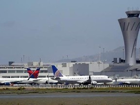 Departing and parked aircraft intersect at San Francisco International Airport, Tuesday, July 11, 2017,