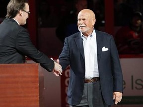 In this Feb. 13, 2016, file photo, Carolina Hurricanes broadcaster John Forslund greets Hurricanes owner Peter Karmanos Jr., right, before the teams&#039; NHL hockey game against the New York Islanders in Raleigh, N.C. Karmanos is considering an offer from someone who wants to purchase the team. Spokesman Mike Sundheim said in a statement attributed to the team that Karmanos ‚Äúalso will continue to evaluate his other options, including retaining his ownership of the team.