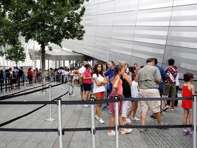 In this July 11, 2017 photo, visitors with timed tickets to the National September 11 Memorial and Museum line up near the museum&#039;s entrance in New York. Last winter the U.S. tourism industry worried about a &ampquot;Trump slump,&ampquot; fearing that Trump administration policies might discourage international travelers from visiting the U.S. But statistics from the first half of 2017 suggest that the travel to the U.S. is robust and a number of sectors have reported increased international visitation, with on