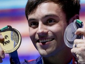Great Britain&#039;s Thomas Daley poses with the gold medal for the men&#039;s 10 meter platform diving final and the silver medal for the mixed 3 meter springboard diving final at the 17th FINA World Championships 2017 in Budapest, Hungary, Saturday, July 22, 2017. (AP Photo/Michael Sohn)