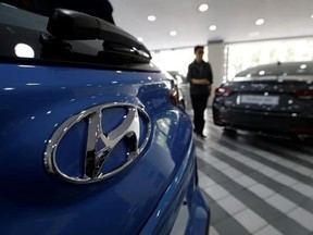 The logo of Hyundai Motor Co. is seen on a car displayed at its showroom in Seoul, South Korea, Wednesday, July 26, 2017. Hyundai Motor said its second-quarter net income plunged 51 percent over a year earlier as sales in China and the U.S. fell sharply. (AP Photo/Ahn Young-joon)