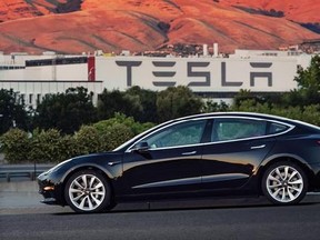 This undated image provided by Tesla Motors shows the Tesla Model 3 sedan. The electric car company‚Äôs newest vehicle, the Model 3, which set to go to its first 30 customers Friday, July 28, 2017, is half the cost of previous models. Its $35,000 starting price and 215-mile range could bring hundreds of thousands of customers into Tesla‚Äôs fold, taking it from a niche luxury brand to the mainstream. (Courtesy of Tesla Motors via AP)